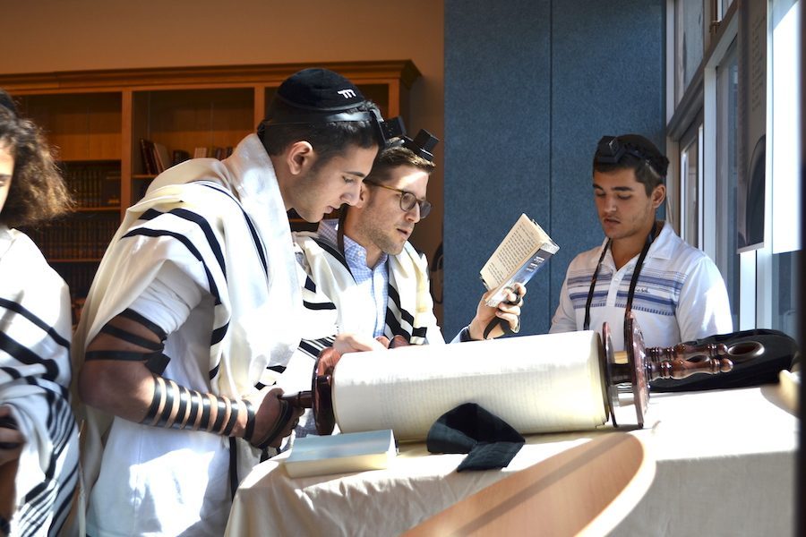 Senior Jeremy Ashagian chanted from the Torah scroll as Rabbi David Block followed along watching for errors. Many students know how to do this, and a few do it professionally on a regular basis at synagogues like B’nai David-Judea and Young Israel of North Beverly Hills.