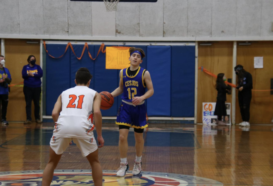 Boys varsity basketball player Sam Sharp brings the ball down the court in a game against Melvin J. Berman Academy on Jan. 29, 2022. This was CESJDS’s second game of the season against their rivals, which they won 48-41.