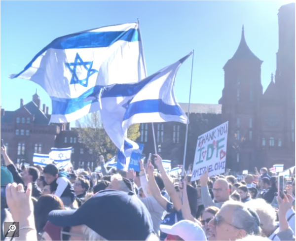 Israeli flags fly in the wind at the March for Israel.