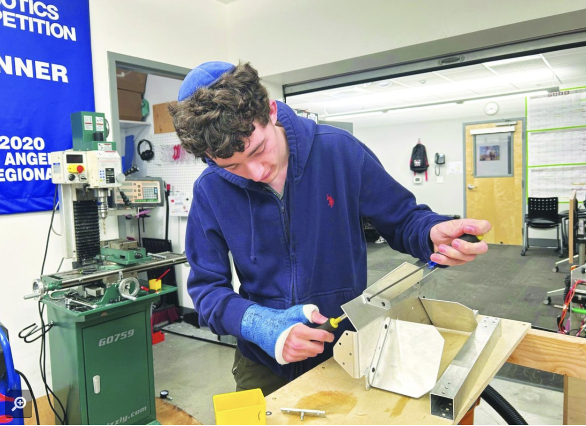 BUILDING: Robotics Captain Benjy Kolieb working on the robot for this year’s competition.